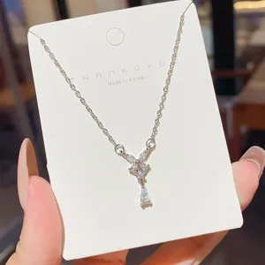 Silver-tone chain displayed on a card, with a crystal butterfly and dangling teardrop pendant
