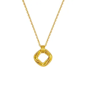 Gold-tone necklace with a fine chain and twisted, beaded square openwork pendant on white