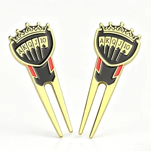 Studio view of two gold-tone fork tools with crown tops and black-red playing-card enamel details