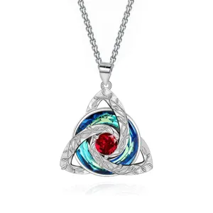 Silver-tone Celtic knot pendant with red center stone and blue-green crystal inlays on white
