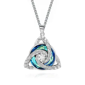Close-up of the Celtic knot pendant, with a clear center stone and blue-green crystal accents