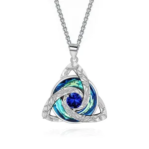 Silver Celtic knot pendant with a blue center stone and blue-green crystals, shown on white