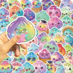 Close-up of a rainbow holographic dumpling sticker with glasses and a pink book, held by hand