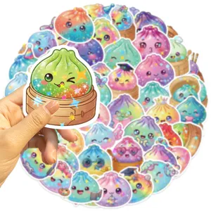 Close-up of a hand holding a glittery green dumpling sticker amid colorful cartoon designs
