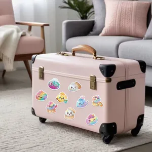 Rainbow glitter cartoon dumpling stickers displayed on a pink suitcase in a softly lit living room