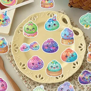 Colorful glittery dumpling character stickers arranged on an ornate cream plate, shown from above