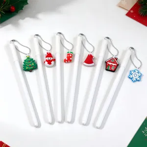 Six white pens arranged flat with silver chains and colorful Christmas-themed charms