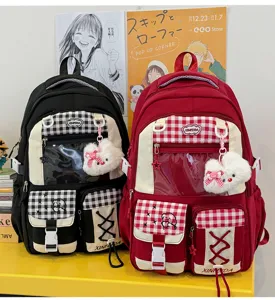 Two backpacks shown side by side, with clear front panels, plaid trim, and plush bear charms