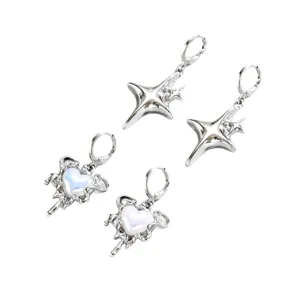 Due paia di orecchini pendenti color argento, con stelle e cuori sfumati blu e rosa su fondo bianco