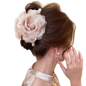 Large beige sheer flower claw clip with pearl accents, shown securing an elegant updo