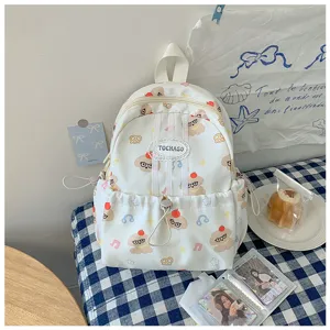 Sac à dos blanc avec motifs d’ours et de canards, poche à cordon à l’avant et étiquette TOCHASO