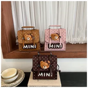 Trois sacs à pois marron, rose et brun foncé, chacun avec un visage d’ours en peluche à l’avant