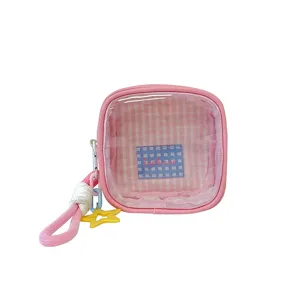 Trousse cosmétique rose avec fenêtre transparente, zip, dragonne et breloque étoile jaune
