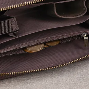 Close-up of a brown fabric-lined wallet compartment with a metal zipper and coins inside