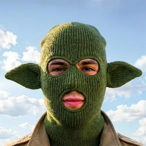Cagoule verte en maille à trois ouvertures et oreilles pointues, portée de face en extérieur