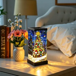 Close-up of a glowing stained-glass Christmas tree and stars on a square bedside lamp