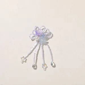 White seed-bead loops with purple flowers, blue crystals, pearls, and clear dangling charms