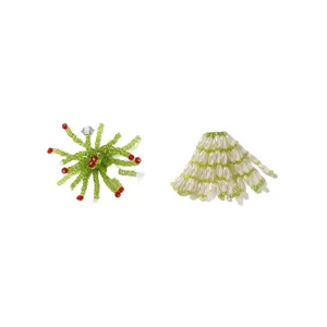 Handmade green and white beaded floral accessories with red accents, shown on a white background