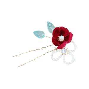 Red velvet flower hairpin with pearl, blue leaf accents, a beaded bow and gold U-shaped prongs