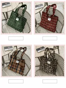Four bags in green and red plaid, brown plaid and leopard print, displayed on a chair outdoors