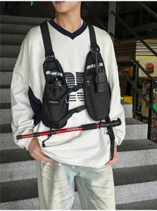 Black chest bag worn over a shirt, showing adjustable straps, bottle pocket and radio pouch