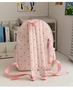 Vue arrière avec bretelles roses, poignée, motif à pois et cœurs, et poche latérale zippée