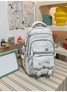 Vue rapprochée d’un sac à dos gris clair avec imprimé léopard, poches avant et boucles