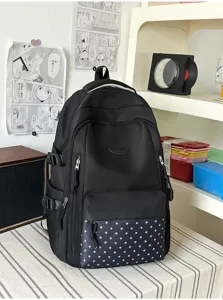 Vue de trois quarts d’un sac à dos noir, avec poche avant à étoiles, bretelles et boucles latérales
