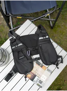 Overhead view of a black chest pack showing mesh back panel, reflective strips and zip pockets