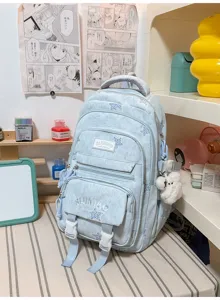 Sac à dos bleu clair avec imprimé étoilé, poches zippées, sangles à boucles et pompon peluche blanc
