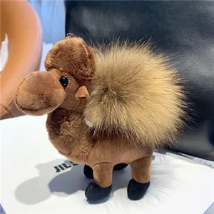 Brown plush camel charm shown with a large fluffy cream pom-pom and a small metal hanging clasp