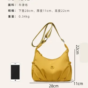Sac bandoulière jaune en toile Oxford, avec corps froncé, sangle réglable et dimensions indiquées