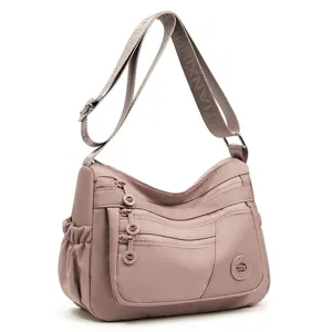 Sac bandoulière rose léger en nylon, avec plusieurs poches zippées et une large sangle réglable