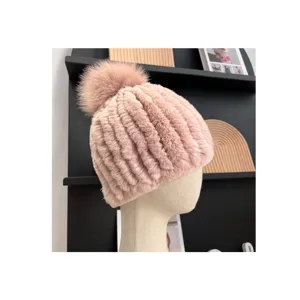 Side view highlighting the pink ribbed knit texture, soft fur pom-pom, and warm plush finish