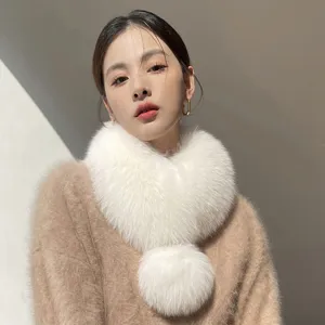 White faux fox-fur neck scarf with a fluffy pom-pom, worn crossed around the neck