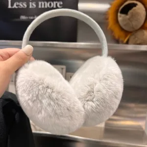 Light gray plush winter earmuffs with a soft curved headband, held up to show their shape