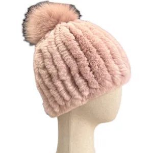 Pink ribbed knitted winter hat with a fluffy fur pom-pom, displayed on a mannequin head
