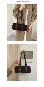 Lifestyle view of a brown suede-texture bag worn over the shoulder, with a hanging bead charm