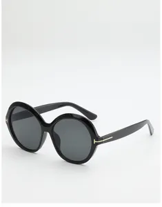 Black round sunglasses with dark gray lenses and gold T-shaped temple accents, shown on white