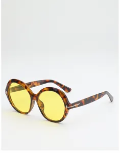 Angled view of round tortoiseshell frames with yellow lenses and a metal T-shaped temple detail