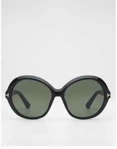Front view of black round sunglasses with green-tinted lenses and small gold T-shaped hinge accents