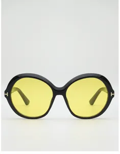 Front view of round black sunglasses with yellow lenses and small gold T-shaped temple accents