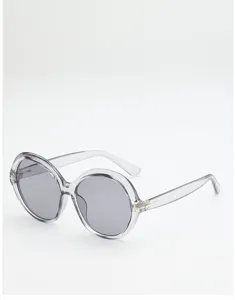 Angled view of round sunglasses with clear gray frames, gray lenses, and subtle metal temple accents