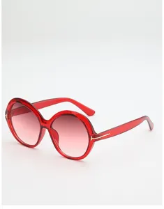 Translucent red round frames with gradient lenses and gold T-shaped accents, shown on white.