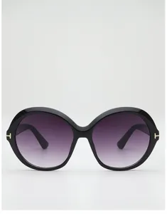 Front view of oversized black round frames, purple-gray gradient lenses, and small gold T accents