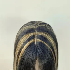 Close-up of a long, straight dark wig with golden highlights and a natural center part