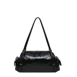 Black glossy bag with a top zipper, long shoulder strap, side bows and gold-tone hardware