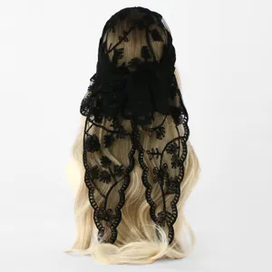 Close-up of black floral lace embroidery and scalloped openwork edge draped over blonde hair