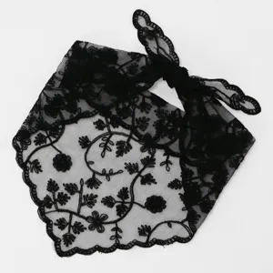 Black sheer scarf laid flat, showing floral vine embroidery, scalloped edges and tied ends
