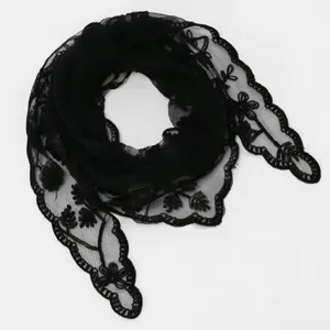Black lace fabric arranged in a loose coil, with sheer mesh and floral embroidered scalloped edges